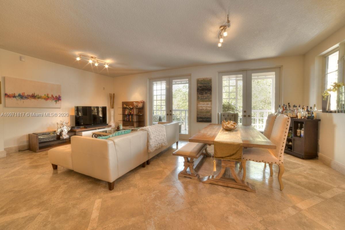 3540 Main Highway, Unit 301 Miami, FL 33133 - Photo 3 of 29 a living room with furniture and a flat screen tv