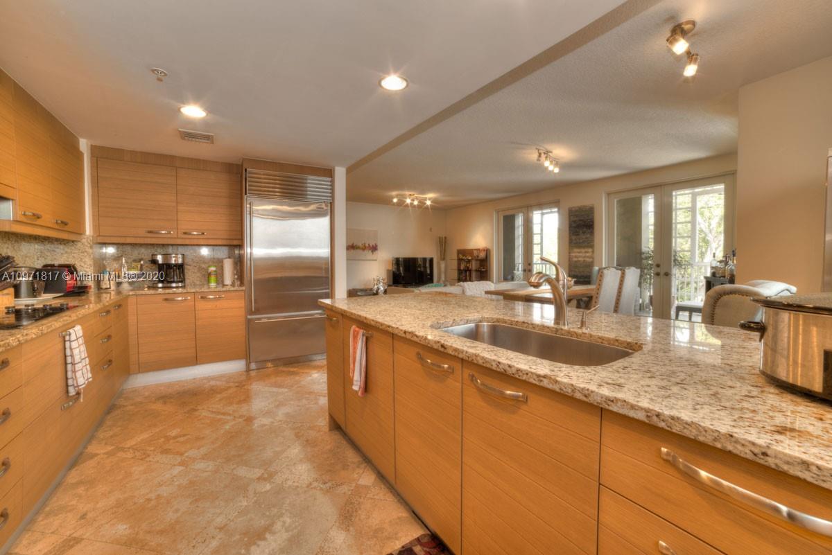 3540 Main Highway, Unit 301 Miami, FL 33133 - Photo 4 of 29 a large kitchen with kitchen island a large counter top