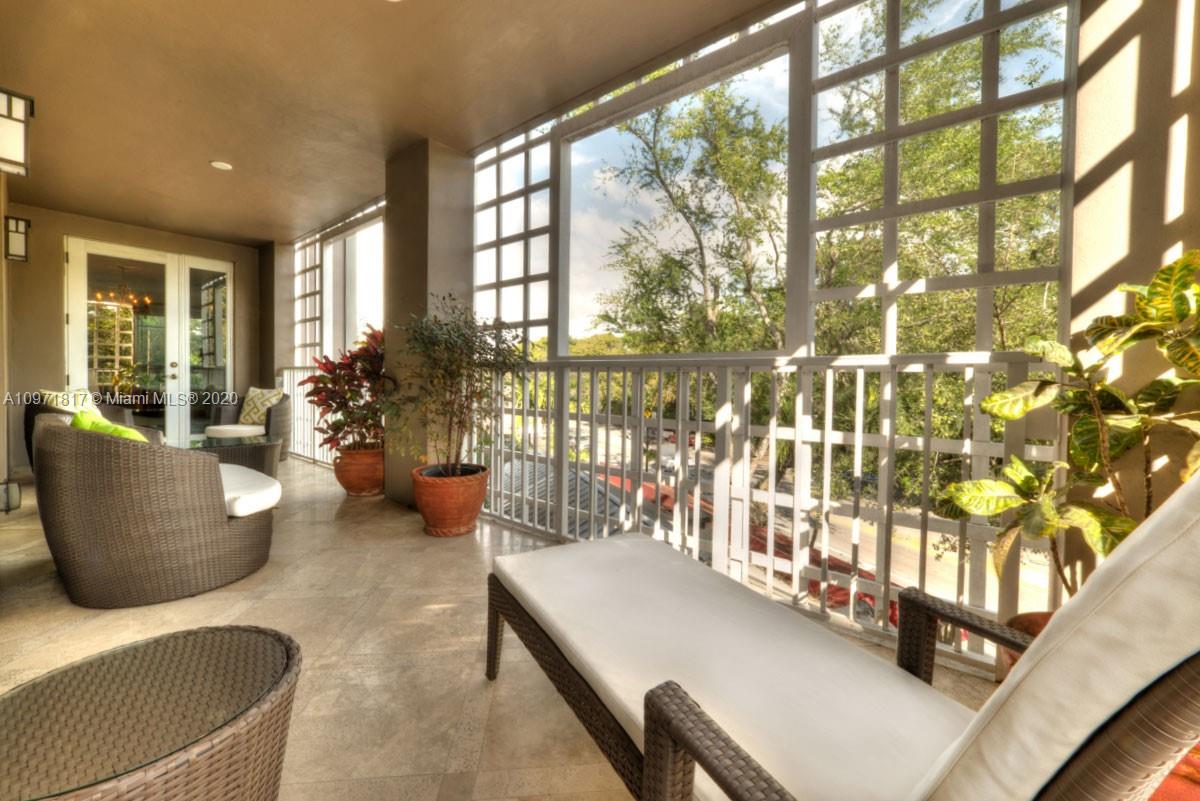 3540 Main Highway, Unit 301 Miami, FL 33133 - Photo 9 of 29 a living room with furniture and a large window