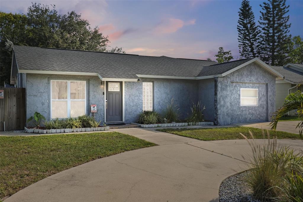 7253 Abington Avenue New Port Richey, FL 34655 - Photo 1 of 1 a front view of a house with a yard and garage