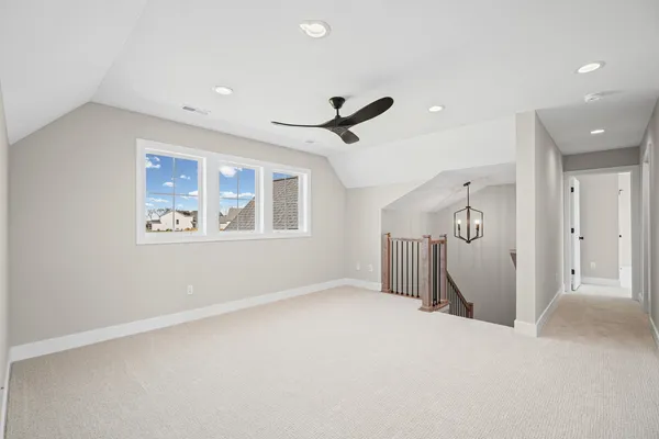 a view of a livingroom with a ceiling fan and window