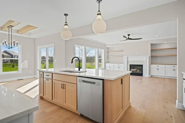 a kitchen with a sink stove and wooden floor