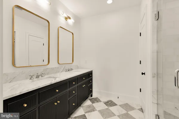 a bathroom with a double vanity sink mirror and