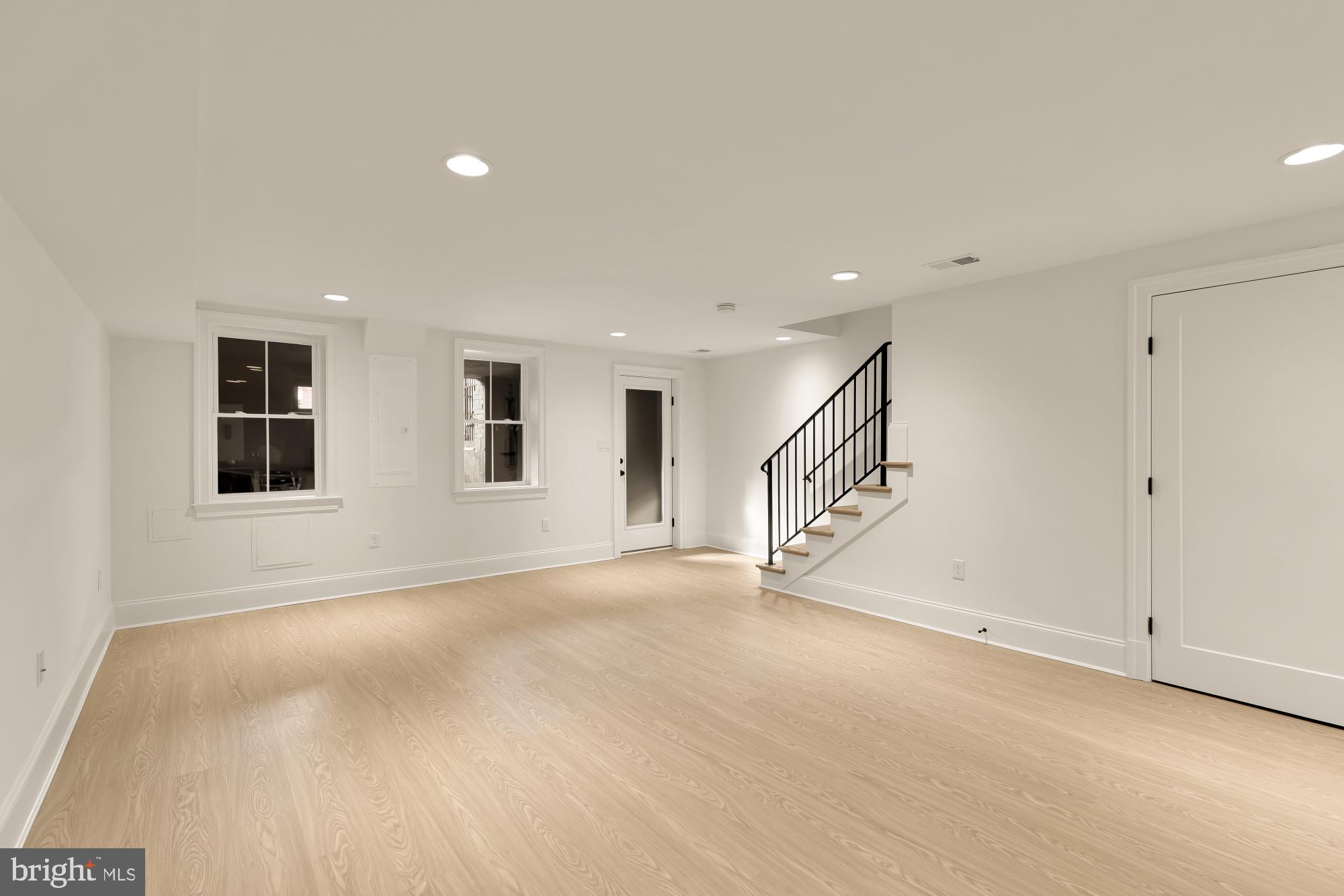 1010 I Street Northeast Washington, DC 20002 - Photo 40 of 51 a view of an empty room with wooden floor and windows