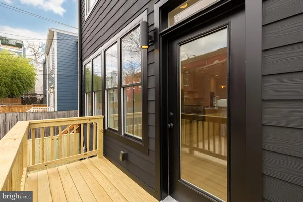 a view of balcony with wooden floor and fence