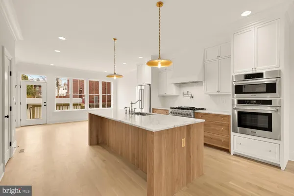 a kitchen with stainless steel appliances a stove sink and microwave