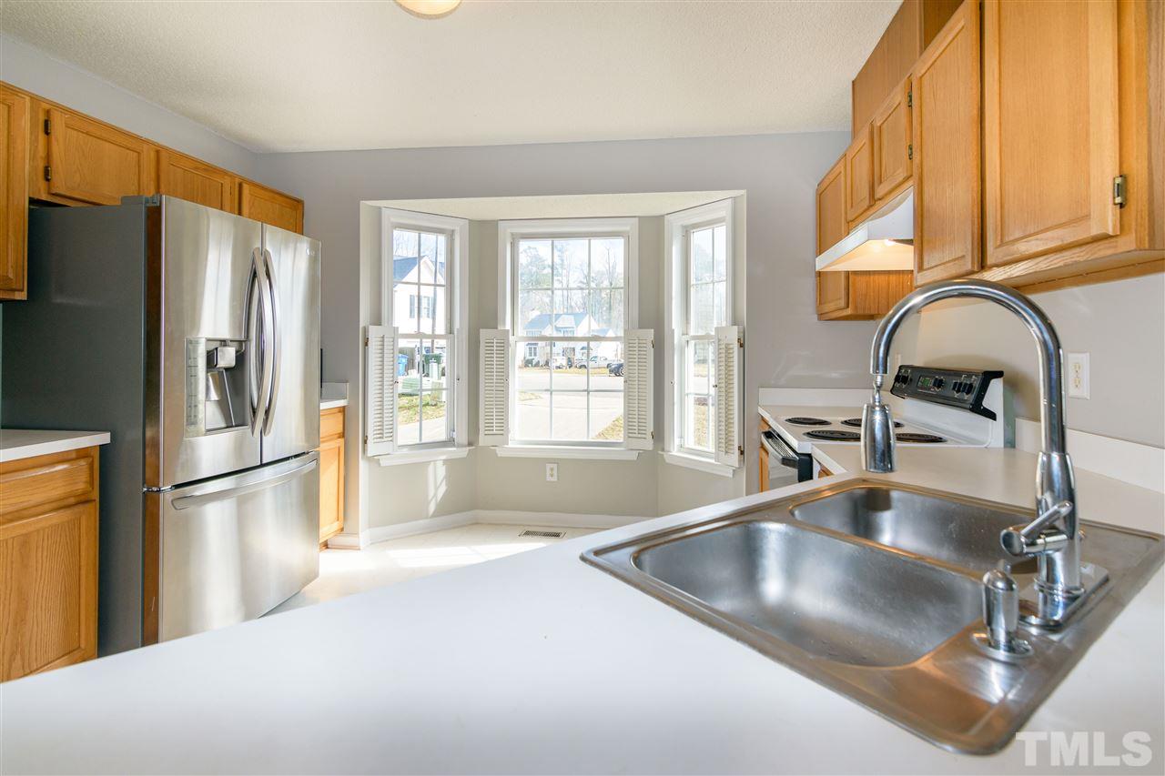 3500 Jaybee Court Raleigh, NC 27604 - Photo 12 of 26 a kitchen with stainless steel appliances granite countertop a refrigerator a sink and a stove