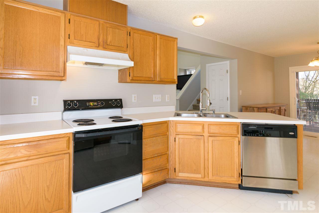 3500 Jaybee Court Raleigh, NC 27604 - Photo 10 of 26 a kitchen with granite countertop white cabinets and white appliances