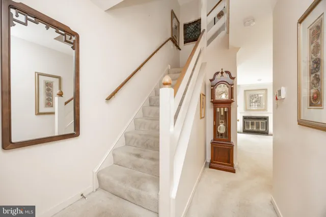 a bedroom with a bed and a dresser next to a window