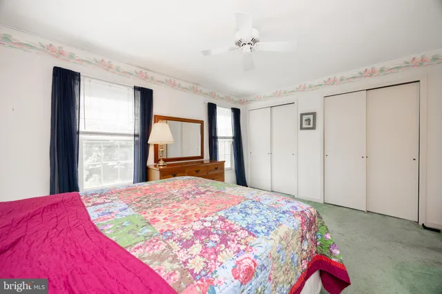 a bedroom with a bed and a mirror