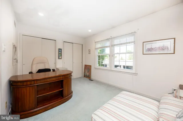 a living room with furniture and large windows