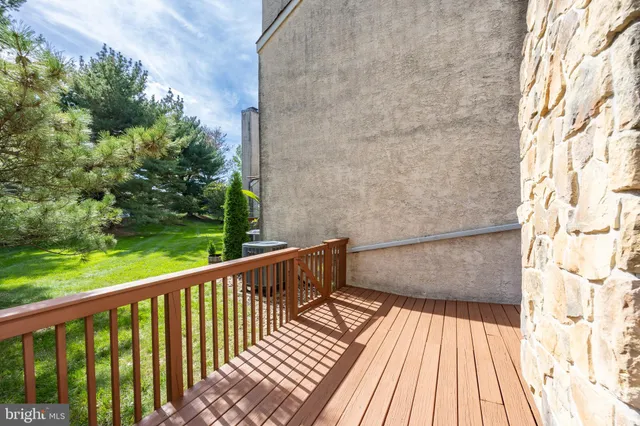 a view of balcony with wooden floor and fence