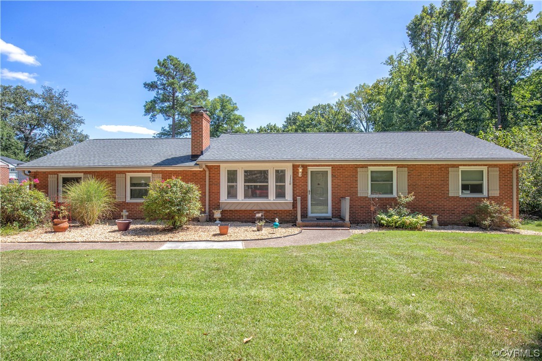 4609 Bruce Road Chester, VA 23831 - Photo 1 of 36 a front view of a house with a yard and trees