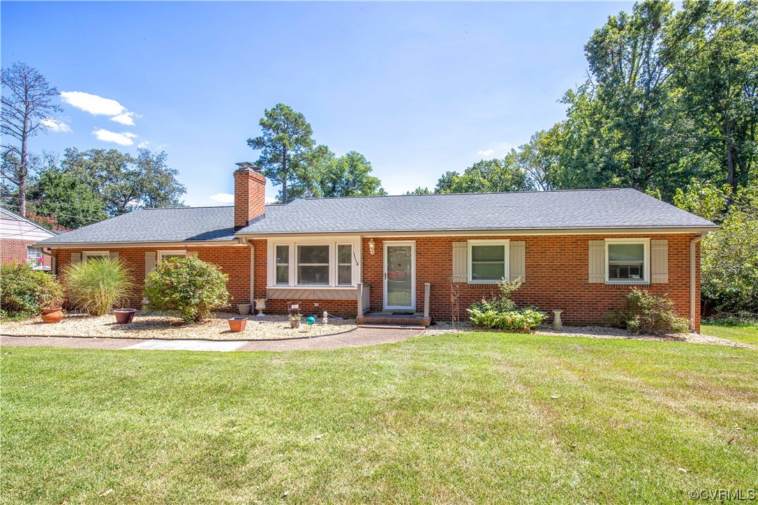 4609 Bruce Road Chester, VA 23831 - Photo 2 of 36 a front view of a house with patio yard and outdoor seating