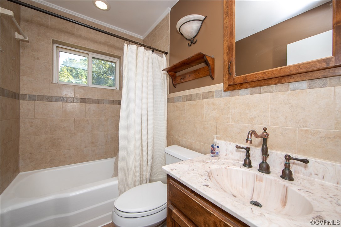 4609 Bruce Road Chester, VA 23831 - Photo 21 of 36 a bathroom with a granite countertop sink toilet and shower