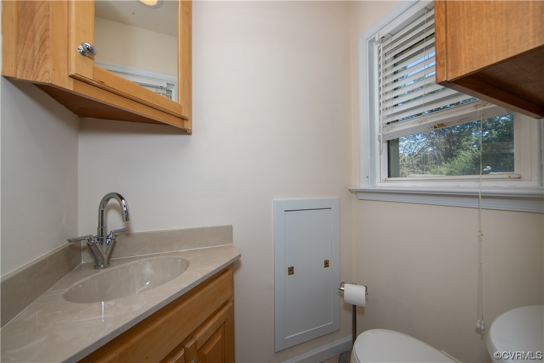 4609 Bruce Road Chester, VA 23831 - Photo 26 of 36 a bathroom with a granite countertop toilet sink and mirror