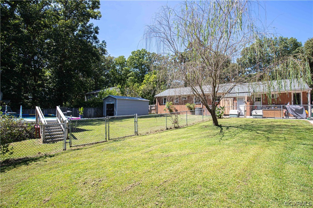 4609 Bruce Road Chester, VA 23831 - Photo 6 of 36 a swimming pool with some trees in the background