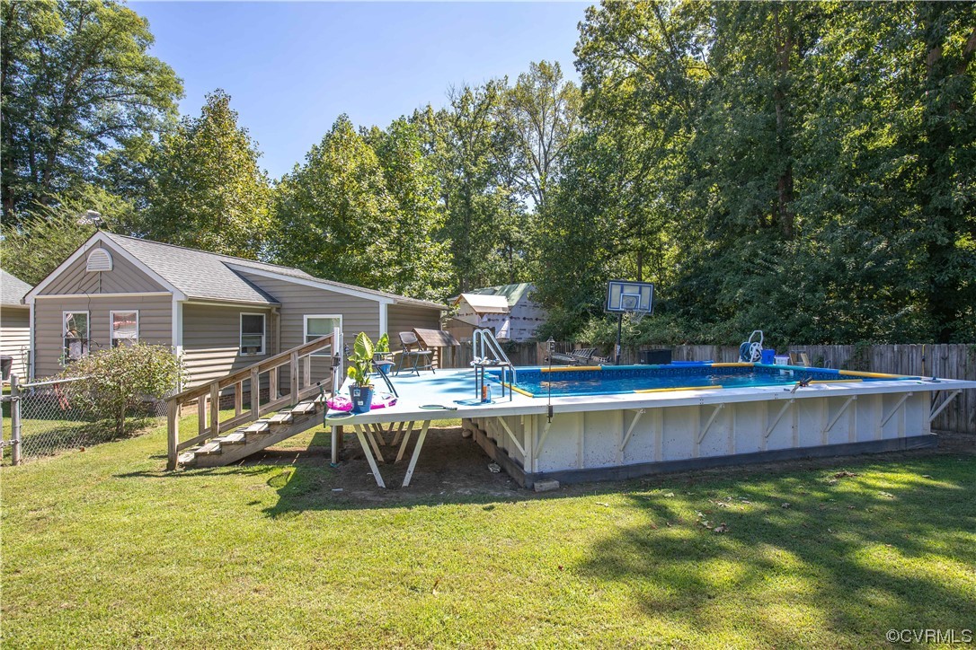 4609 Bruce Road Chester, VA 23831 - Photo 7 of 36 a view of a house with pool and a yard