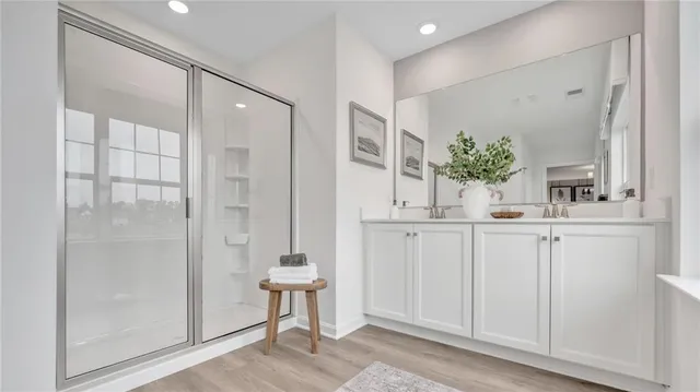 a kitchen with white cabinets and window