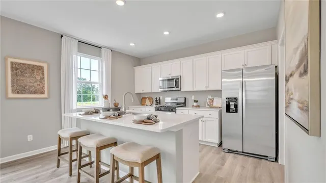 a kitchen with a sink and a white cabinets