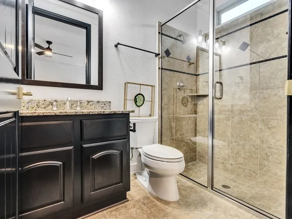 a bathroom with a sink toilet and shower