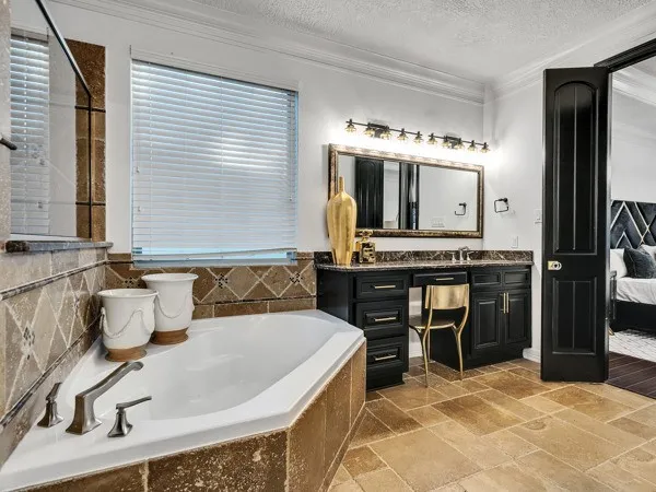 a large kitchen with stainless steel appliances a stove and a refrigerator