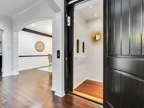 an empty room with wooden floor and a hallway