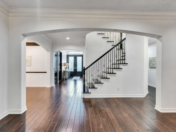 a living room with furniture wooden floor and a table
