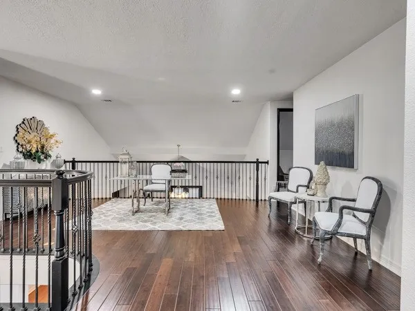 a dining room with wooden floor a glass table and chairs