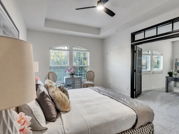 a living room with furniture and large windows