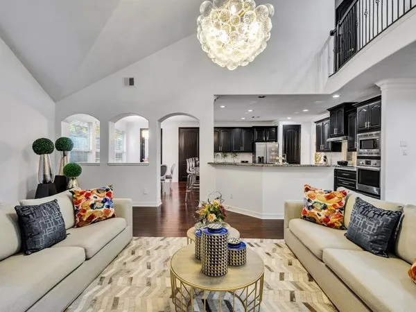 a living room with furniture and kitchen view