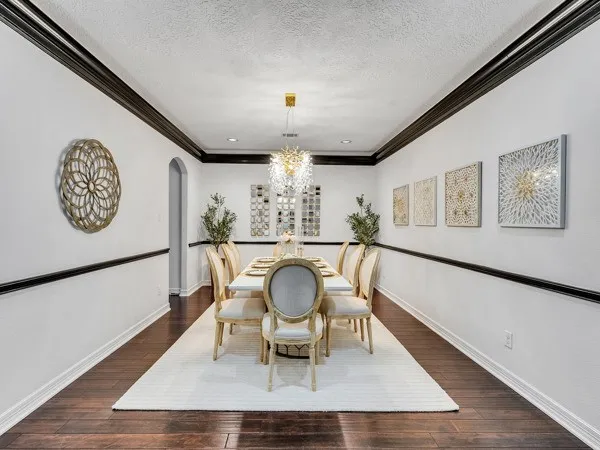 a dining room with furniture and a large mirror
