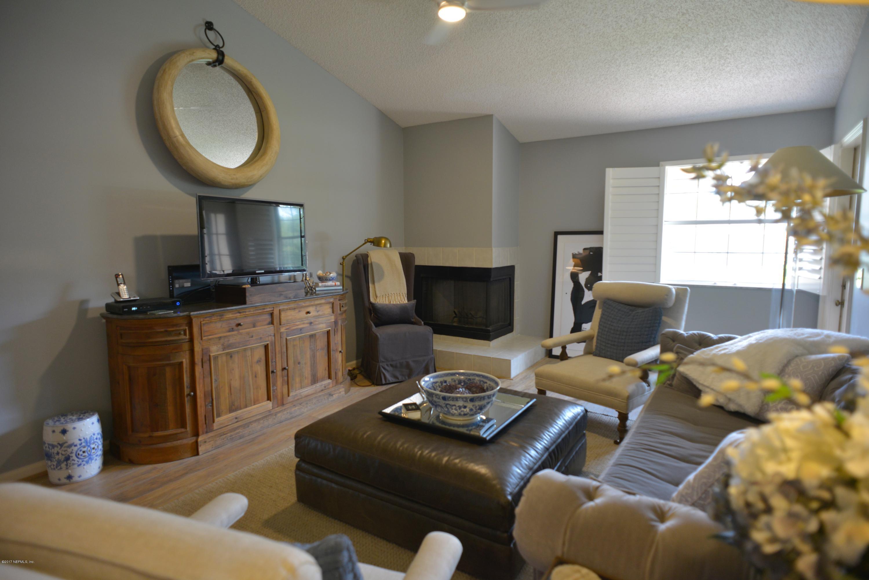 104 Tournament Road Ponte Vedra Beach, FL 32082 - Photo 8 of 50 a living room with furniture a fireplace and a chandelier