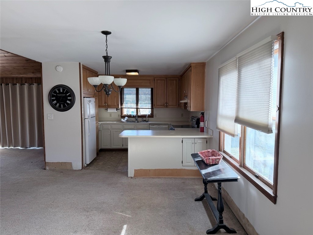 2752 Broadstone Road Banner Elk, NC 28604 - Photo 20 of 24 a kitchen with a refrigerator a sink and a stove