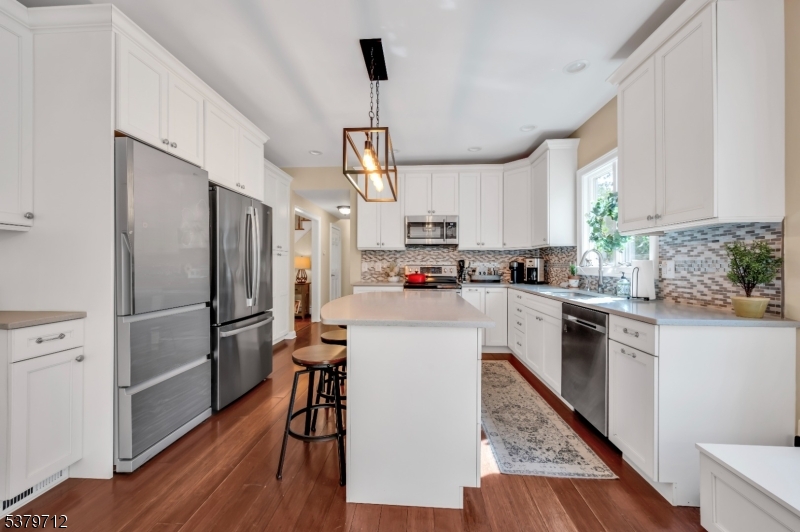 40 Heiser Road Port Murray, NJ 07865 - Photo 20 of 48 a kitchen with kitchen island wooden floors appliances cabinets and a center island