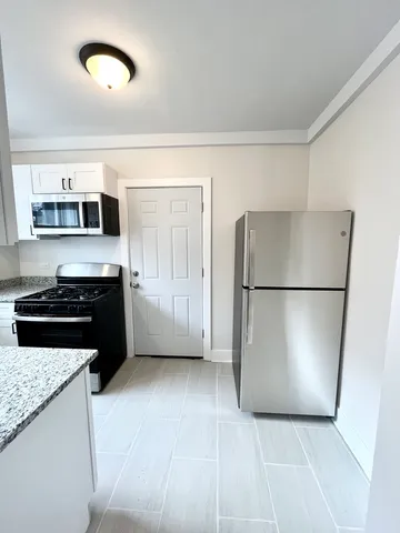 a kitchen with a sink a refrigerator and a stove
