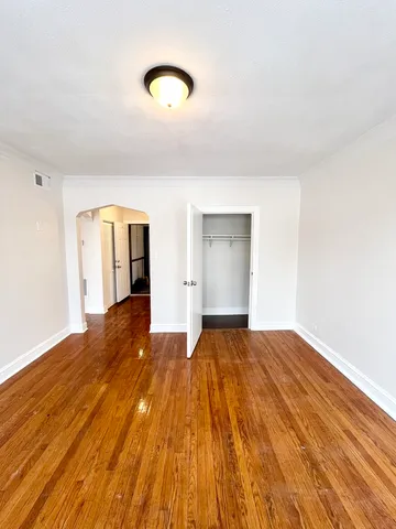 a view of an empty room and wooden floor