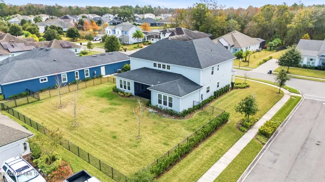 a view of patio with chairs and table under an umbrella