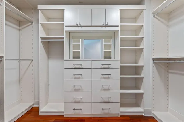 a large bathroom with a large tub shower double vanity sink and a mirror
