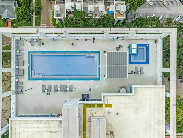aerial view of a house with a yard and lawn chairs