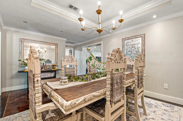 a view of a dining room with furniture wooden floor and chandelier