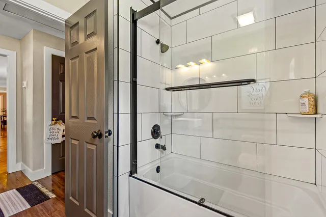 a bathroom with a bathtub and shower