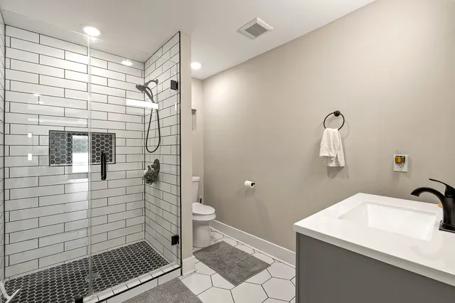 a bathroom with a sink toilet and shower