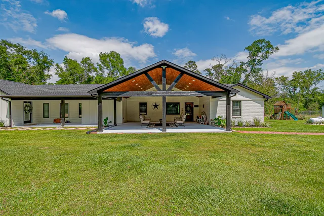 a front view of a house with swimming pool having outdoor seating