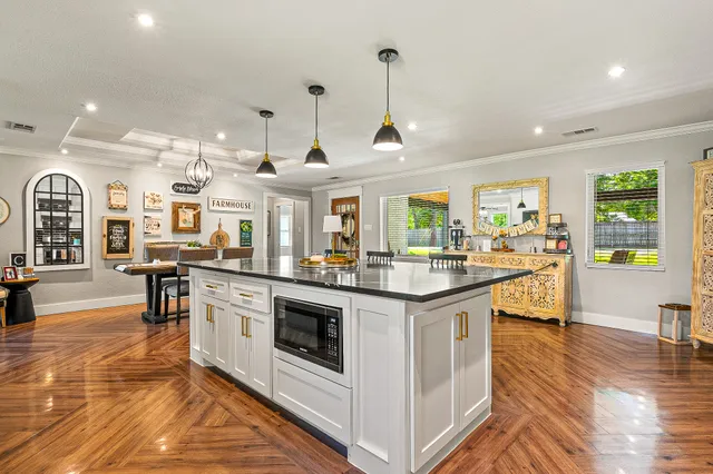 a kitchen with stainless steel appliances granite countertop a stove and cabinets
