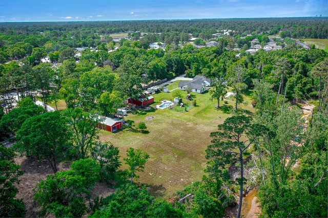 an aerial view of a houses with a yard