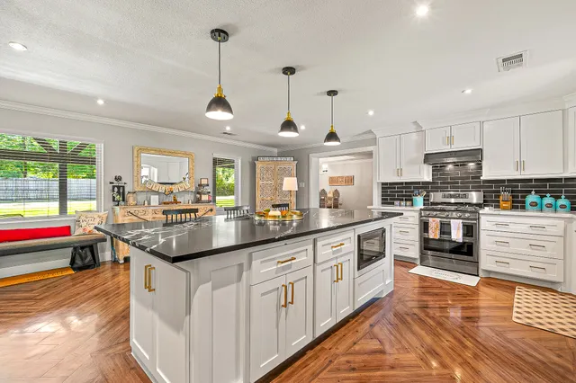 a kitchen with stainless steel appliances granite countertop a sink and cabinets