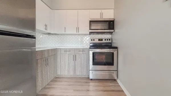 a kitchen with a stove and a microwave