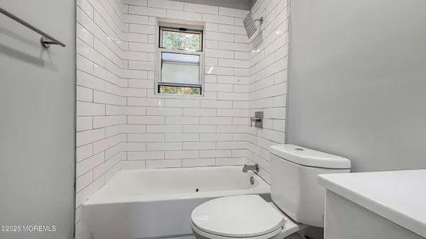 a white toilet and a bath tub