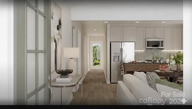 a kitchen with stainless steel appliances kitchen island granite countertop a refrigerator and a stove top oven